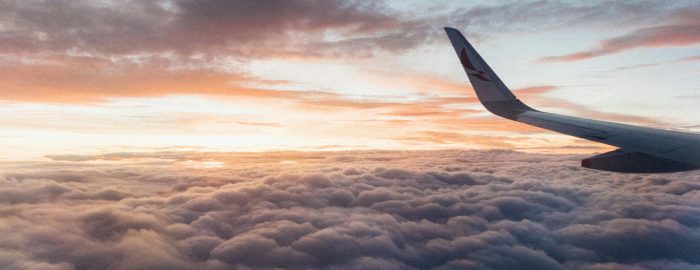 pexels-photo-2007401-2007401-1 Captivating view from the airplane showcasing clouds and vibrant sunset hues, conveying the essence of air travel.